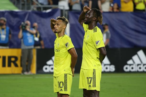 NASHVILLE, TN - SEPTEMBER 03: Nashville SC midfielder Hany Mukhtar (10) and Nashville SC forward C.J. Sapong (17) celebrate a goal with salutes to the crows during an MLS match between Nashville SC and New York City, September 3, 2021, at Nissan Stadium in Nashville, Tennessee. (Photo by Matthew Maxey/Icon Sportswire via Getty Images)
